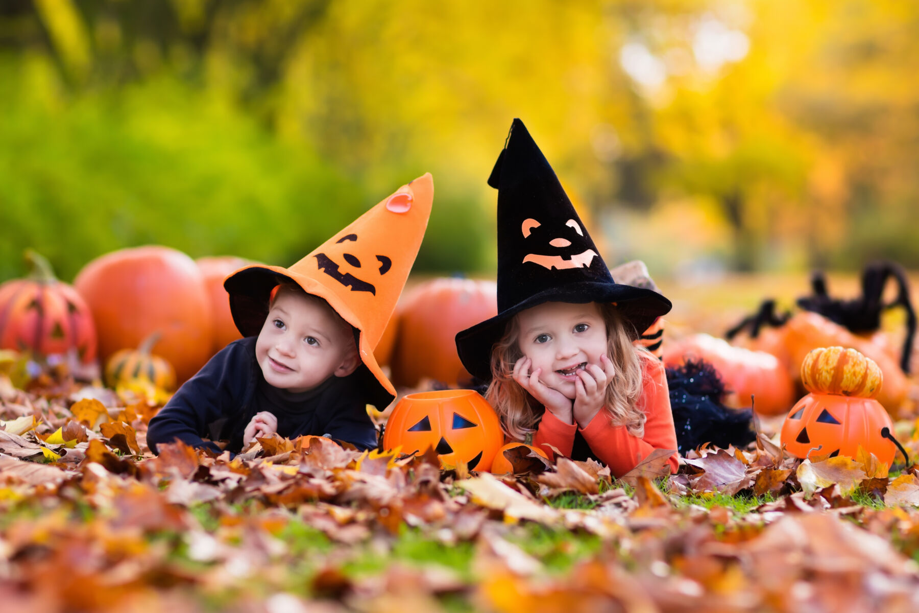 children in halloween hats with pumpkins