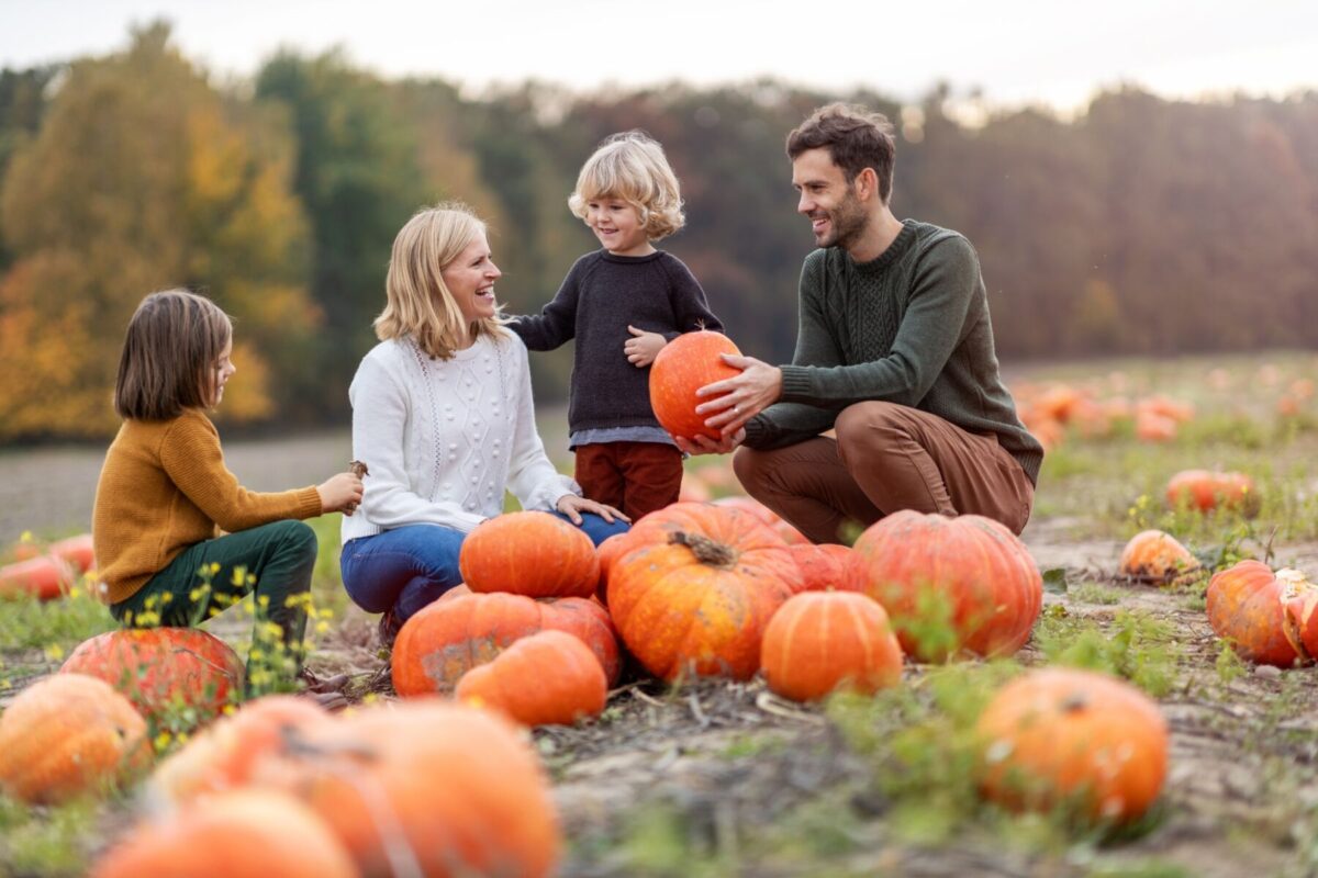 family in pumpkin patch