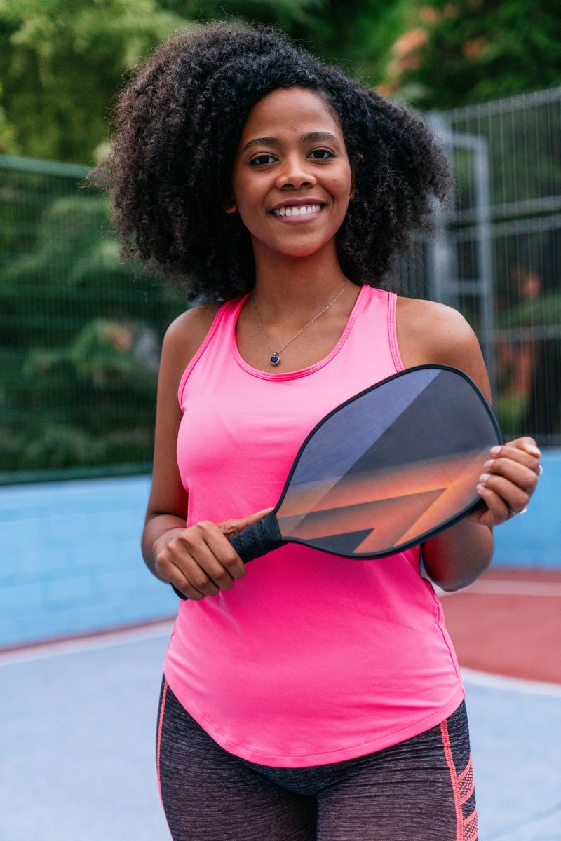 woman holding a picklbell paddle